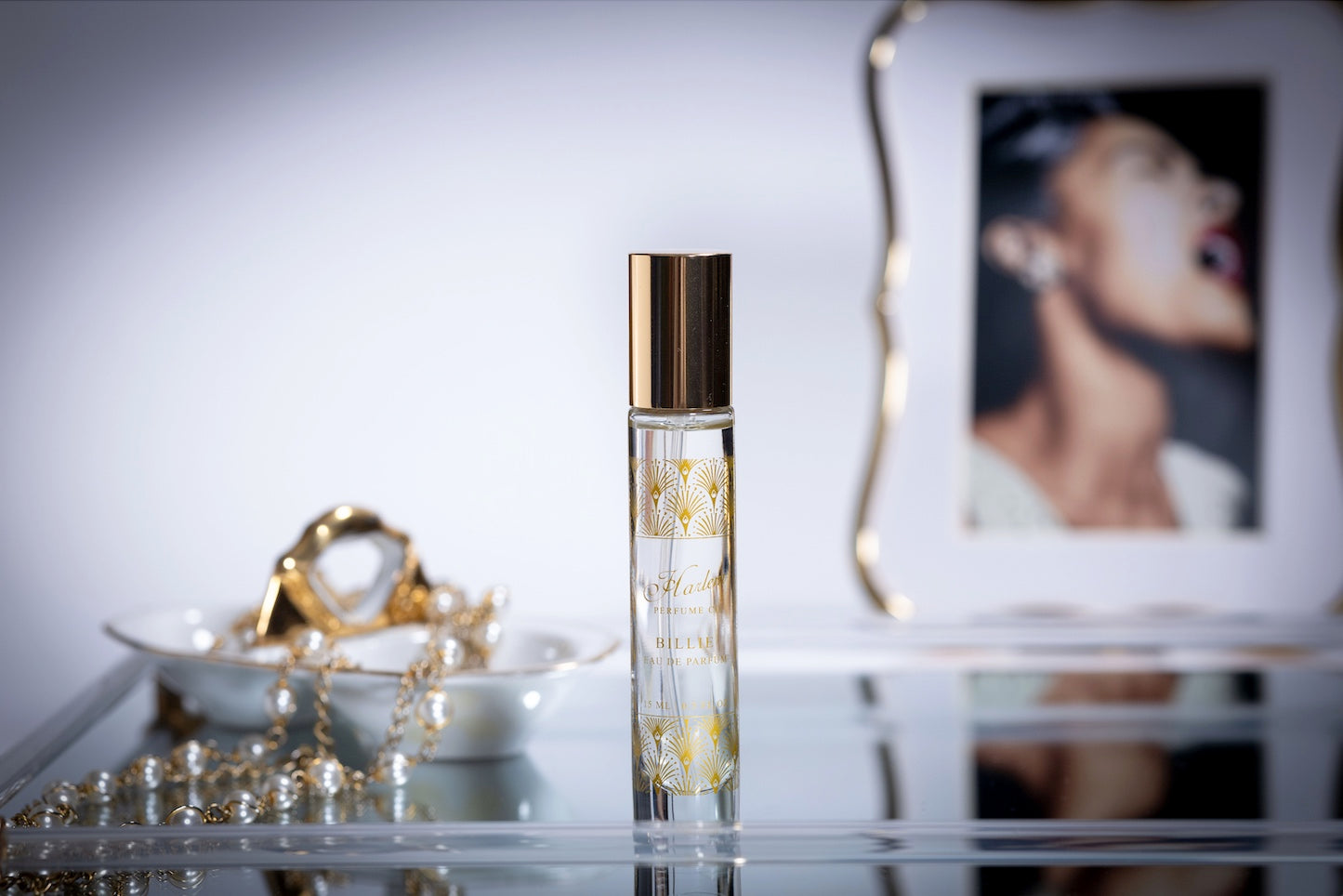 This is a lifestyle image of our Billie 15 ml perfume bottle with an image of Billie Holiday in the background.