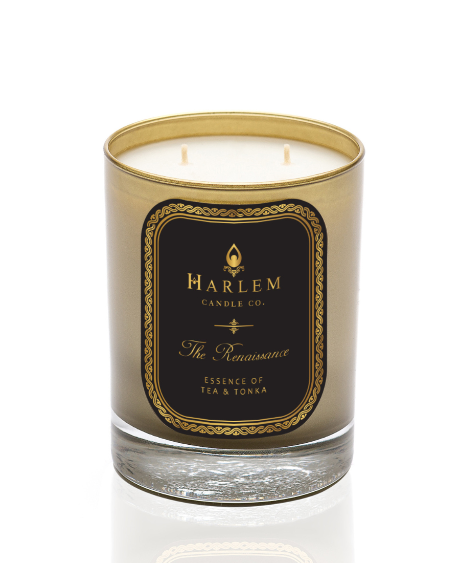 This is an image of The Renaissance Candle pictured in a gold glass with a black and gold label.