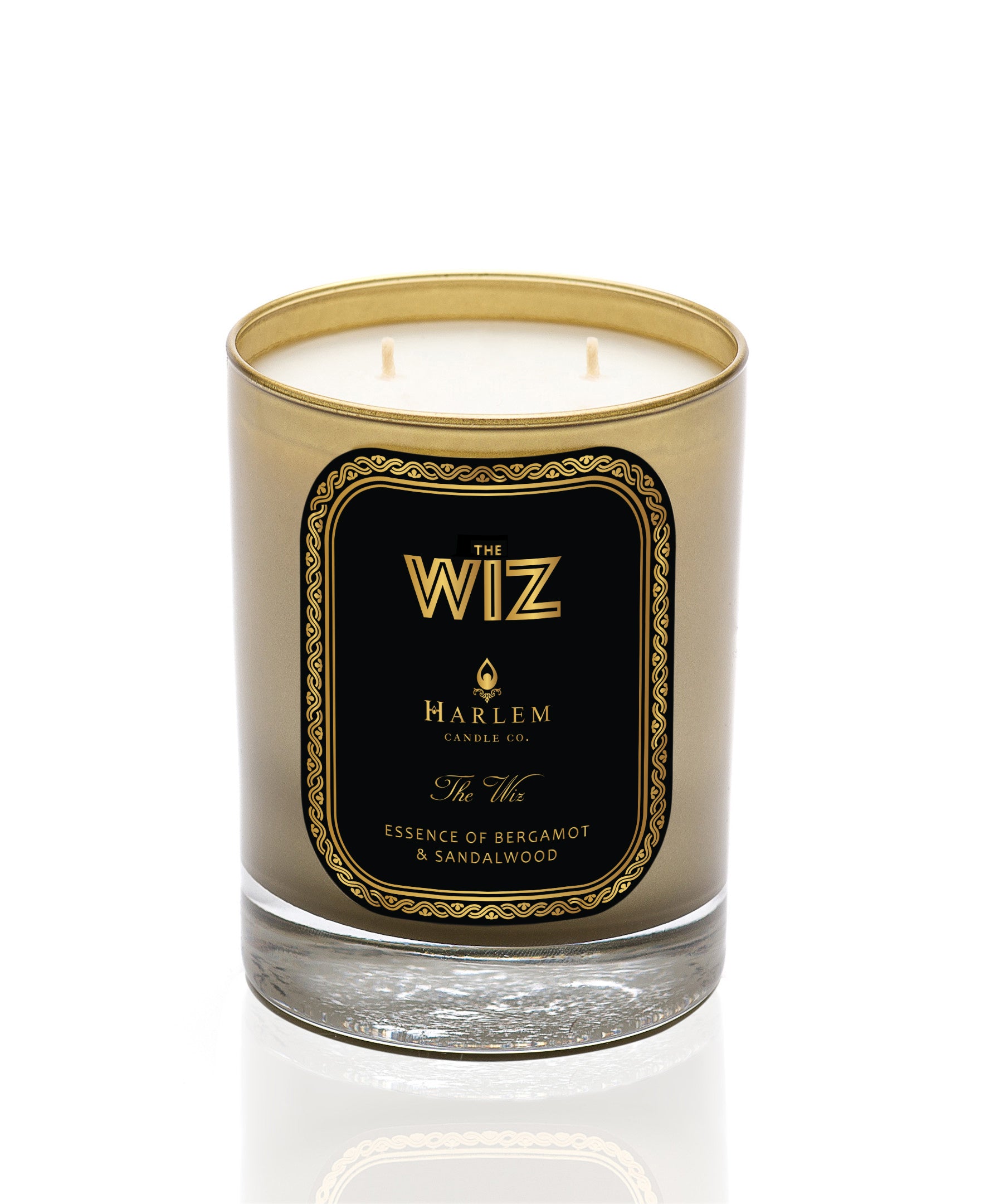 This is an image of the wiz candle in a gold glass with a black and gold label