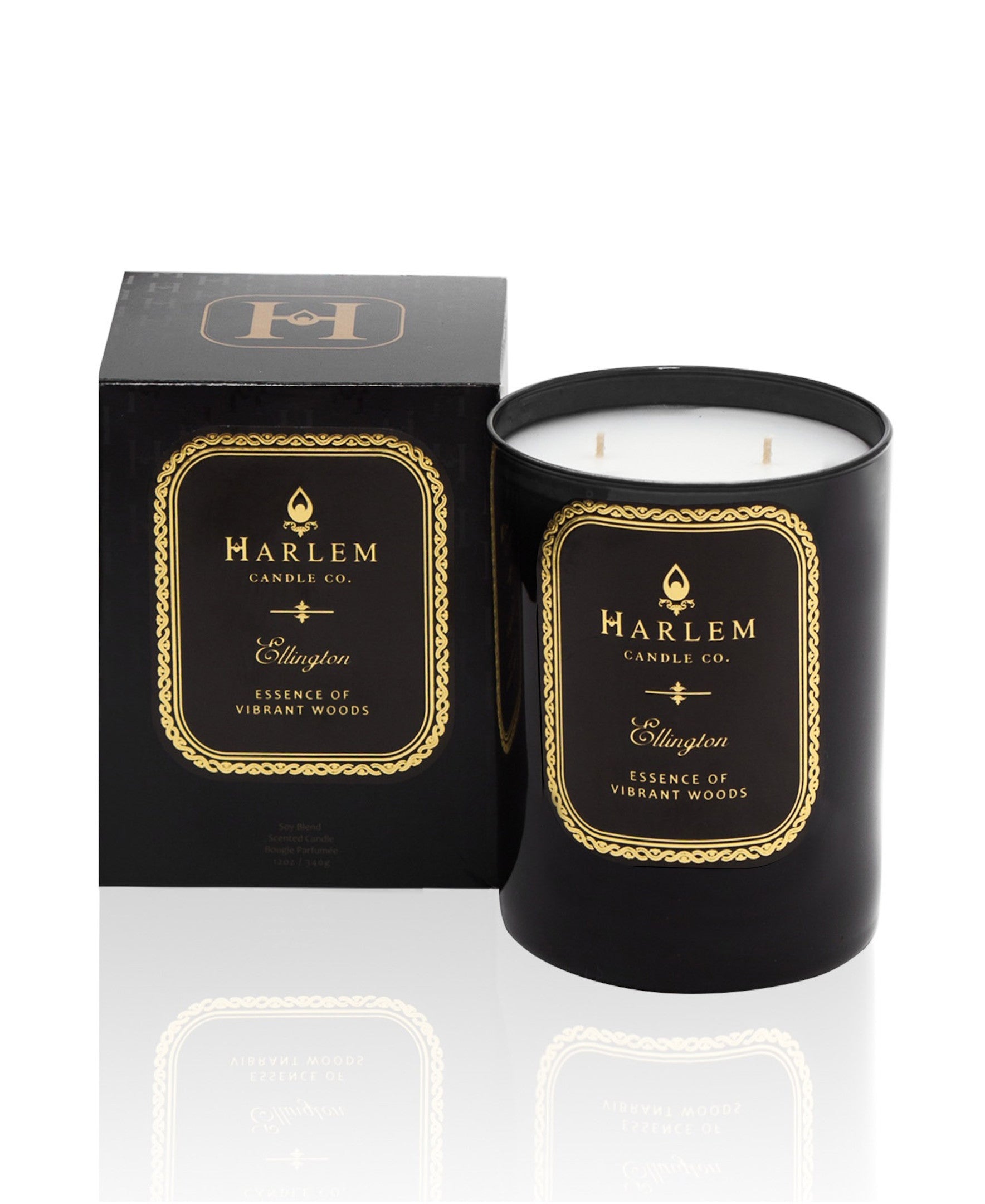 Our black Ellington 12 oz 2 wick candle with essence of vibrant woods sitting next to its decorative box.