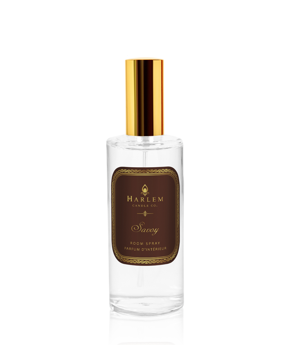 Our clear bottle of 4 oz Savoy room spray with a gold top and the essence of tropical enchantment on a white background.