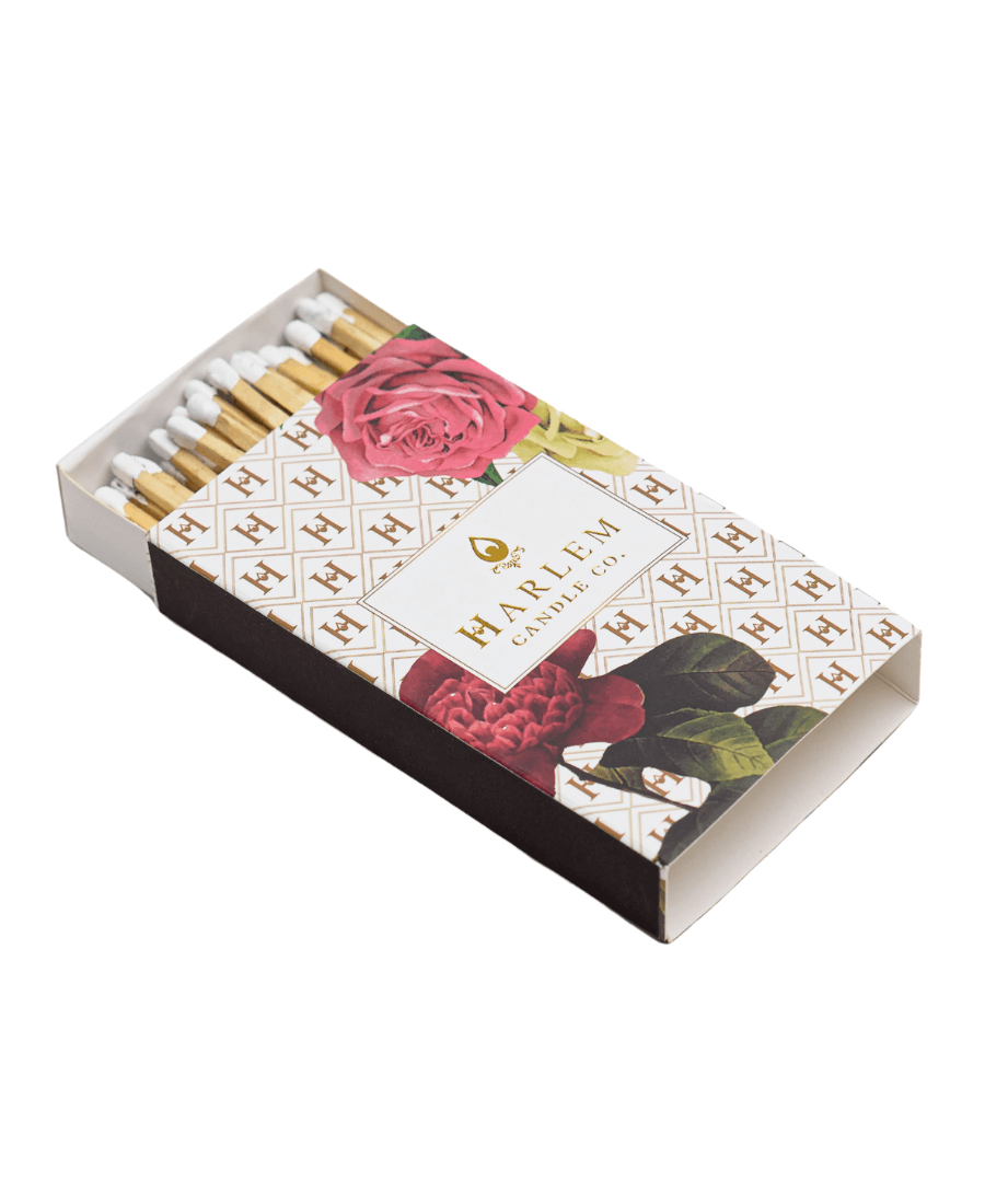 Our Harlem candle Co Art Deco Floral  match box containing 3 inch wooden matches with black tips. The box has the Harlem H pattern in a pink/red floral art deco style printed on the box.
