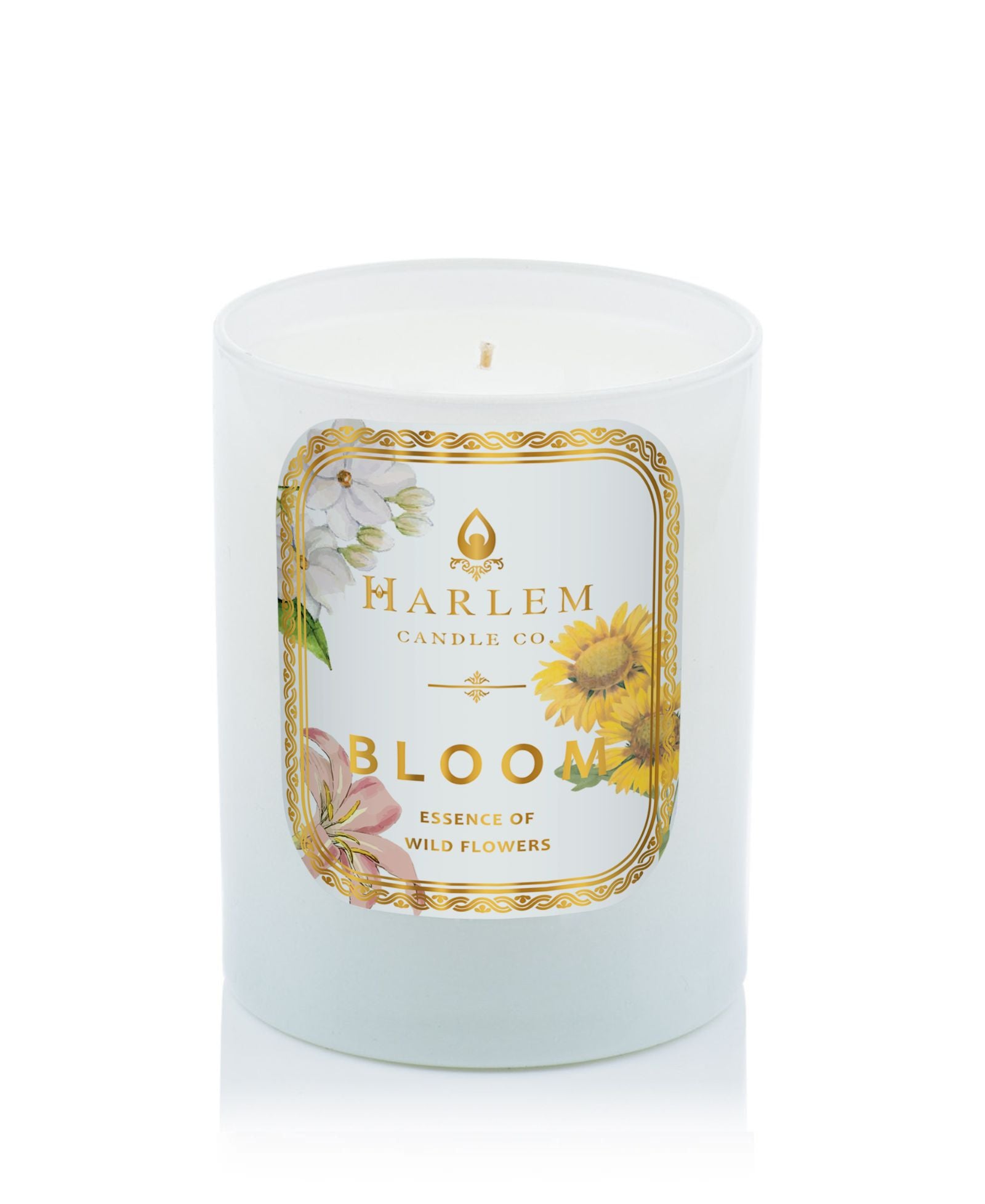 This is an image of our bloom candle in a white glass with flowers on the label.