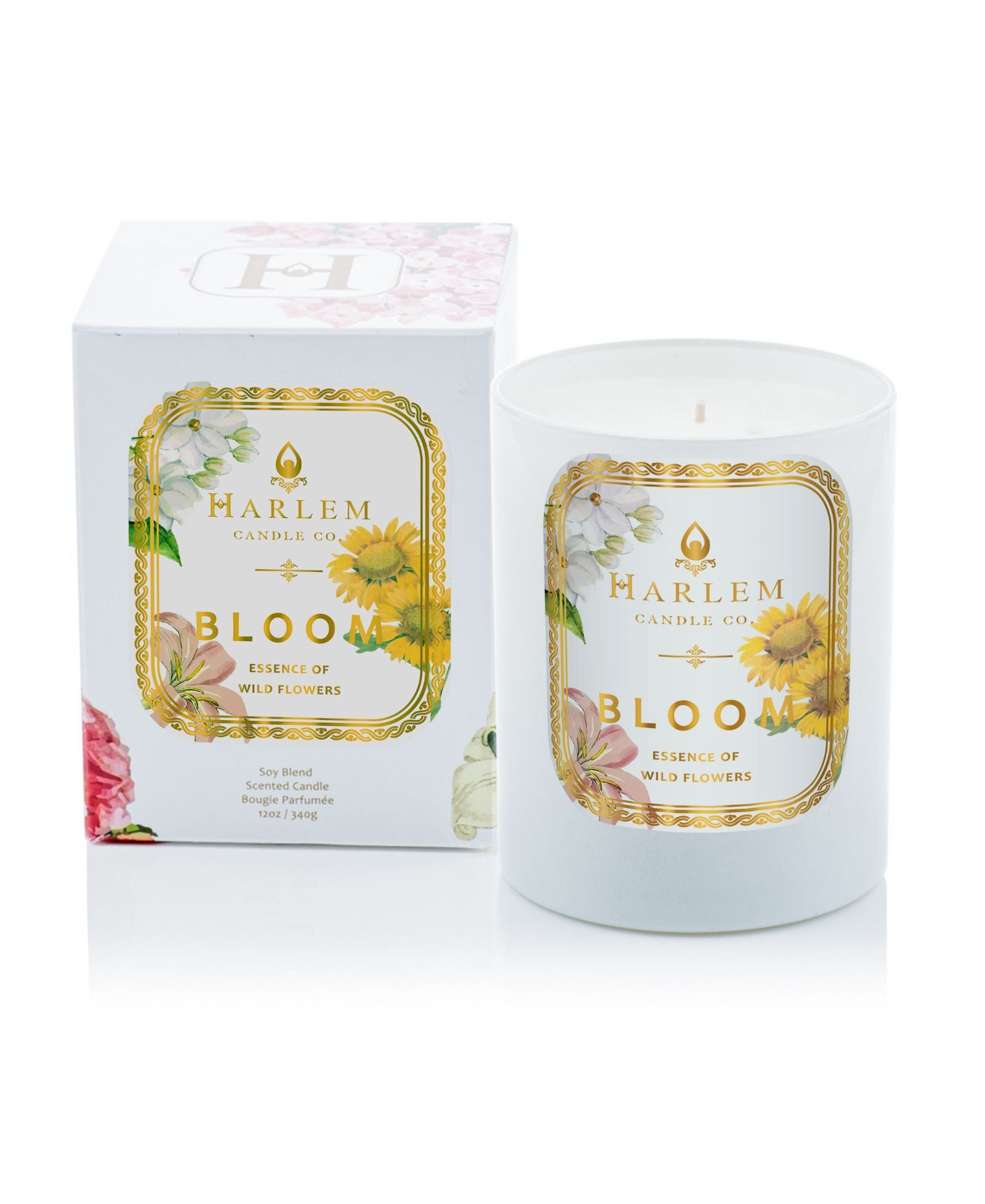 This is an image of our bloom candle in a white glass with a floral design on the label pictured next to its decorative box.