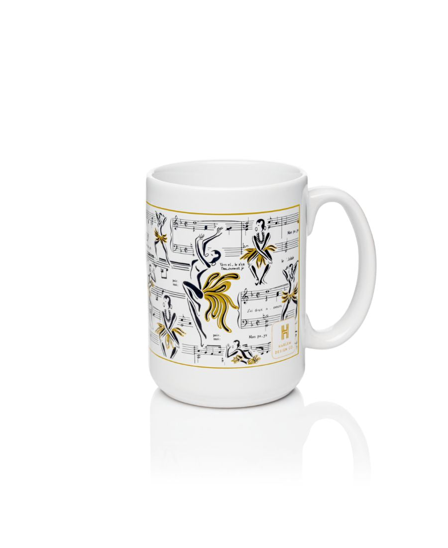 White mug with illistartions of Josephine Baker dance with her music notes in the background. White mug with black and gold art.