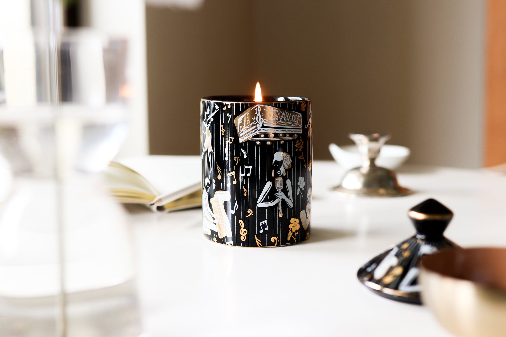 This is an image of our duke, Harlem Renaissance candle in black, white and gold.