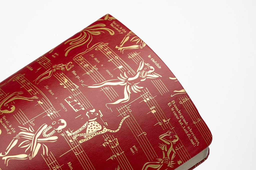 This is a close-up image of the gold detail and illustration on the Josephine red and gold journal