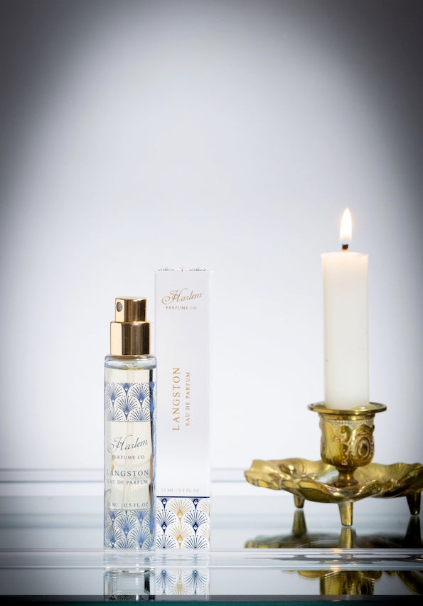 This is a lifestyle image of our Langston 15 ML Perfume picture next to A. gold candle holder with white candle.