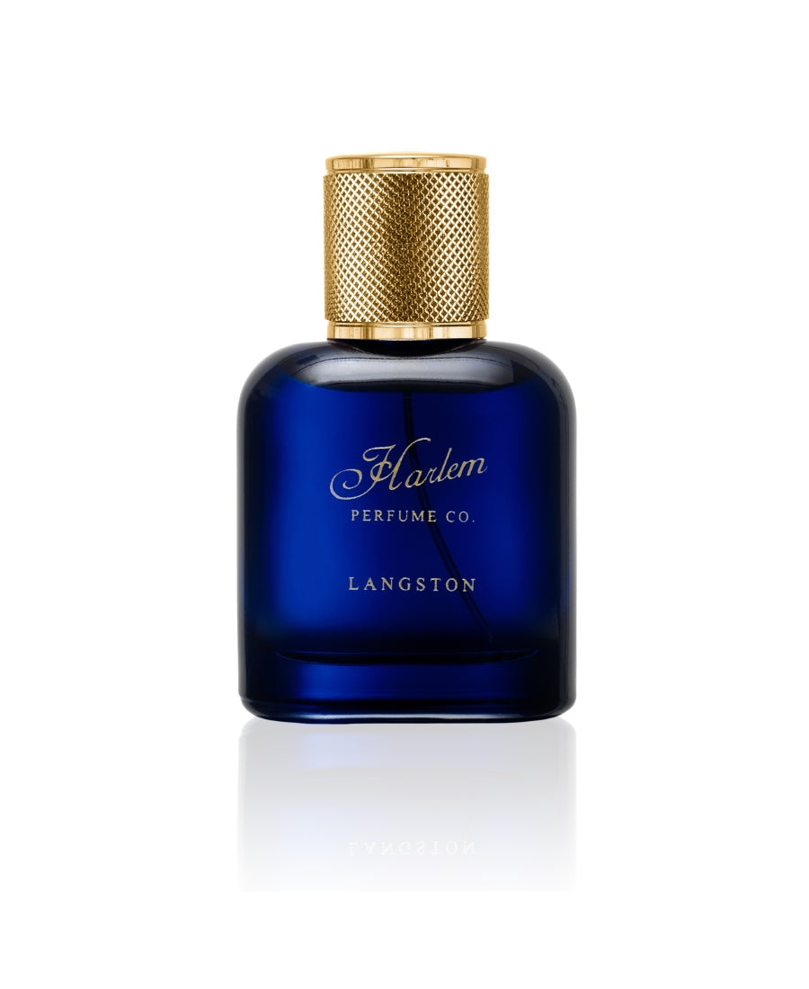 A beautiful blue perfume bottle called Langston with a textured gold cap with a white background.