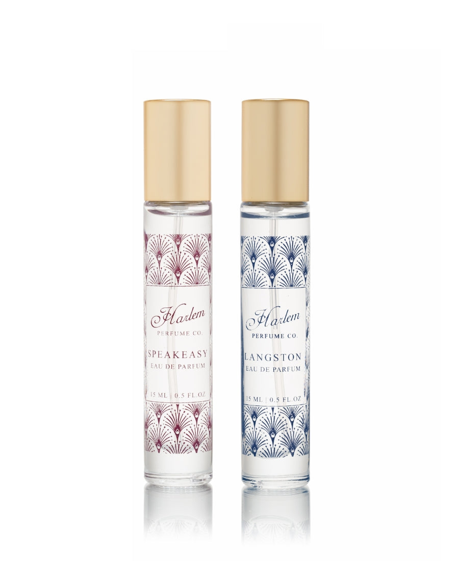 Two perfume 15ml glass bottles. Speakeasy has burgundy artwork and Langston has blue artwork.
