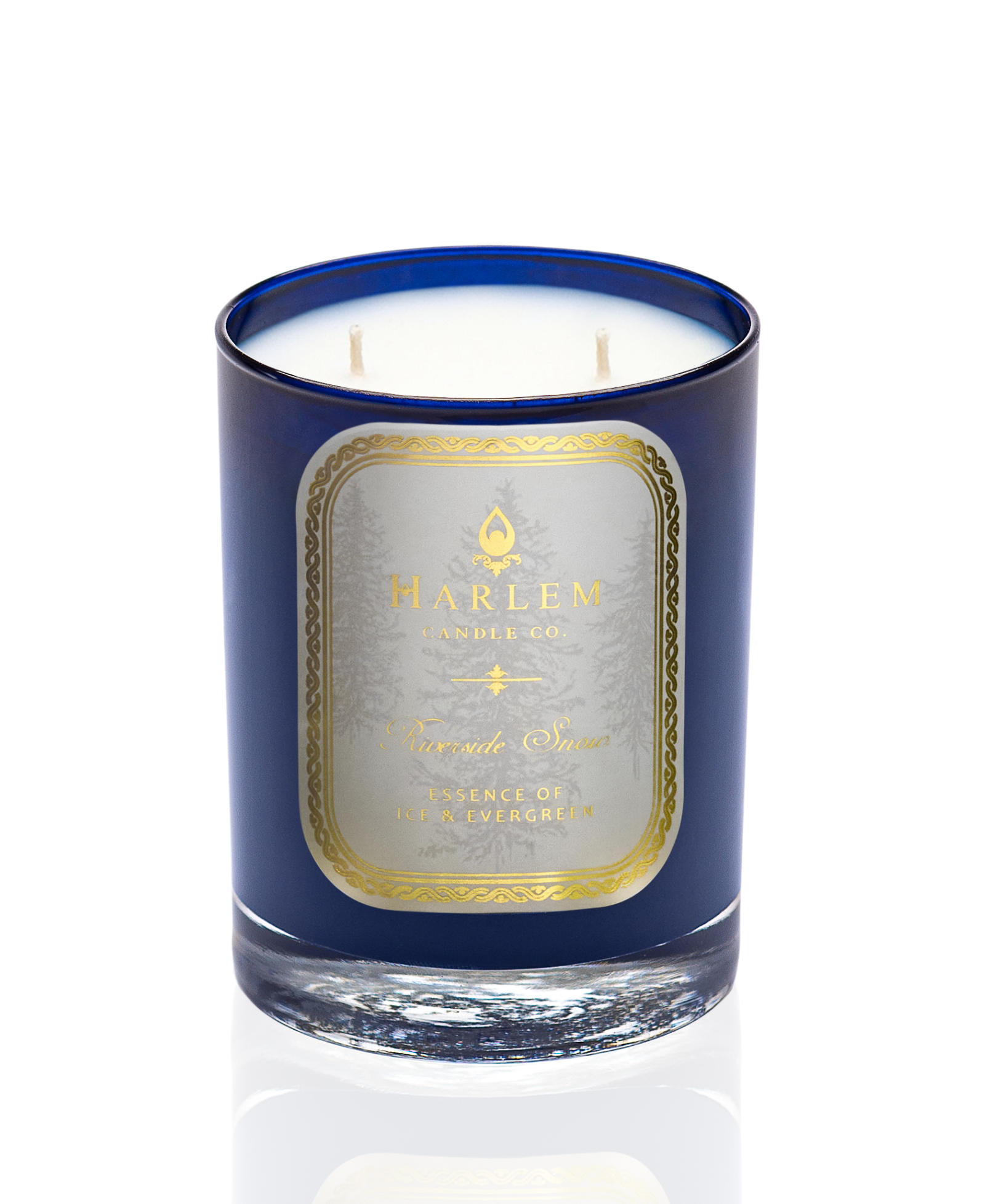 Riverside Snow 2-wick candle in a bright blue glass with a cream and gold label on the front with a white background.