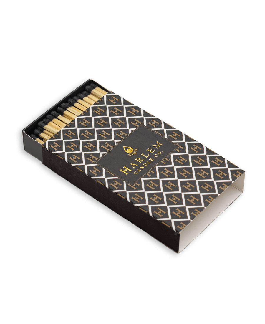 Match box containing 3 inch matches with black tips.  The box has the Harlem H pattern in an art deco style printed on the box.