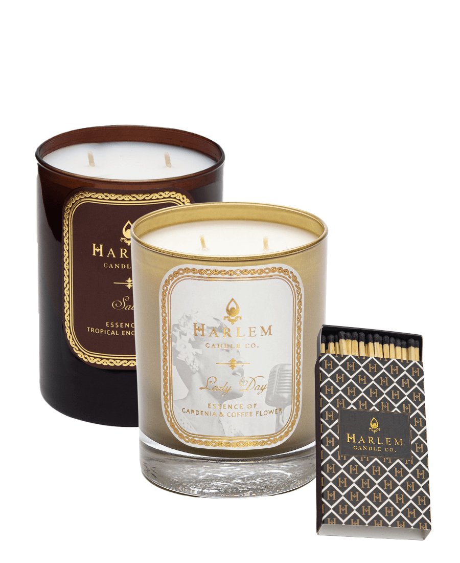 Our Amber Glass Savoy 12 oz 2 wick candle and our Lady Day 12 oz 2 wick gold glass candle with our H Pattern match box with 3 inch black tip matches, on a white background.