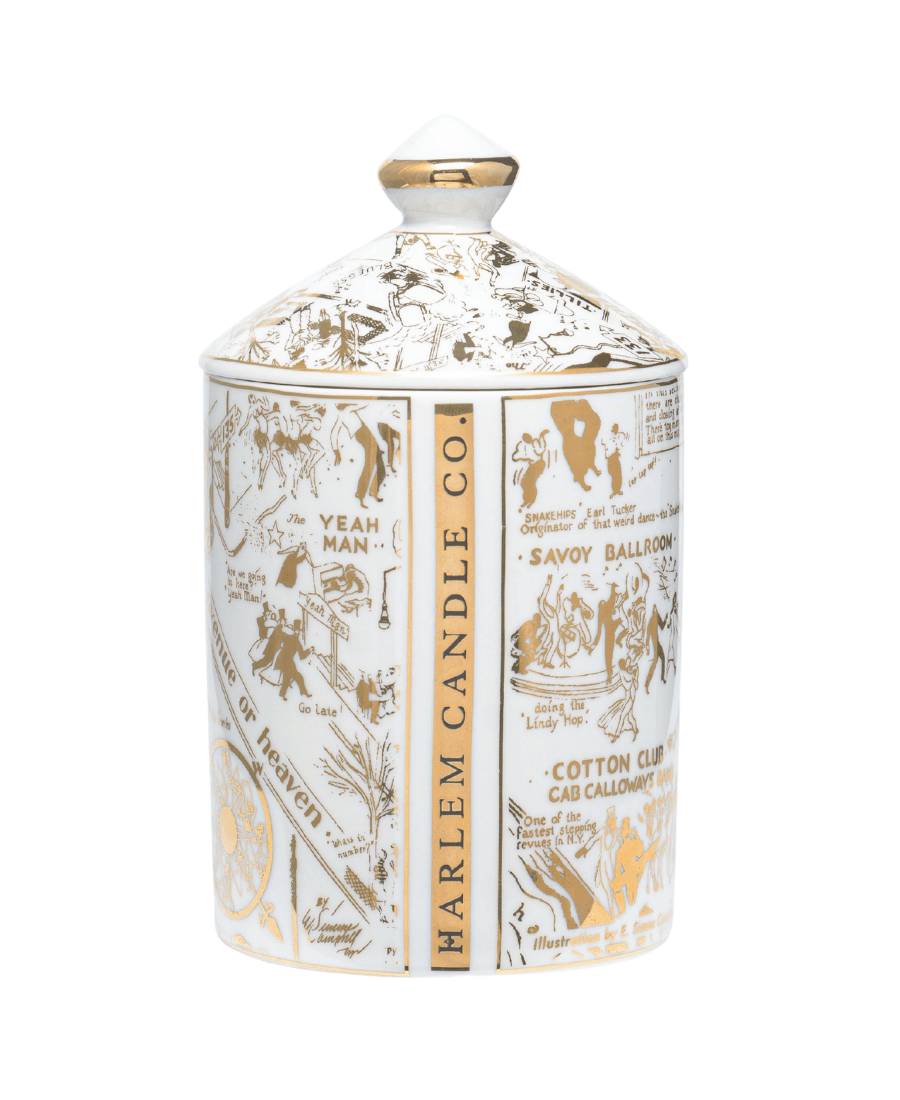 The back side of our Our Speakeasy Map Ceramic Candle with Lid with the Night Club Map of Harlem etched in gold on the ceramic with a white background and the words Harlem Candle Co etched in the side.