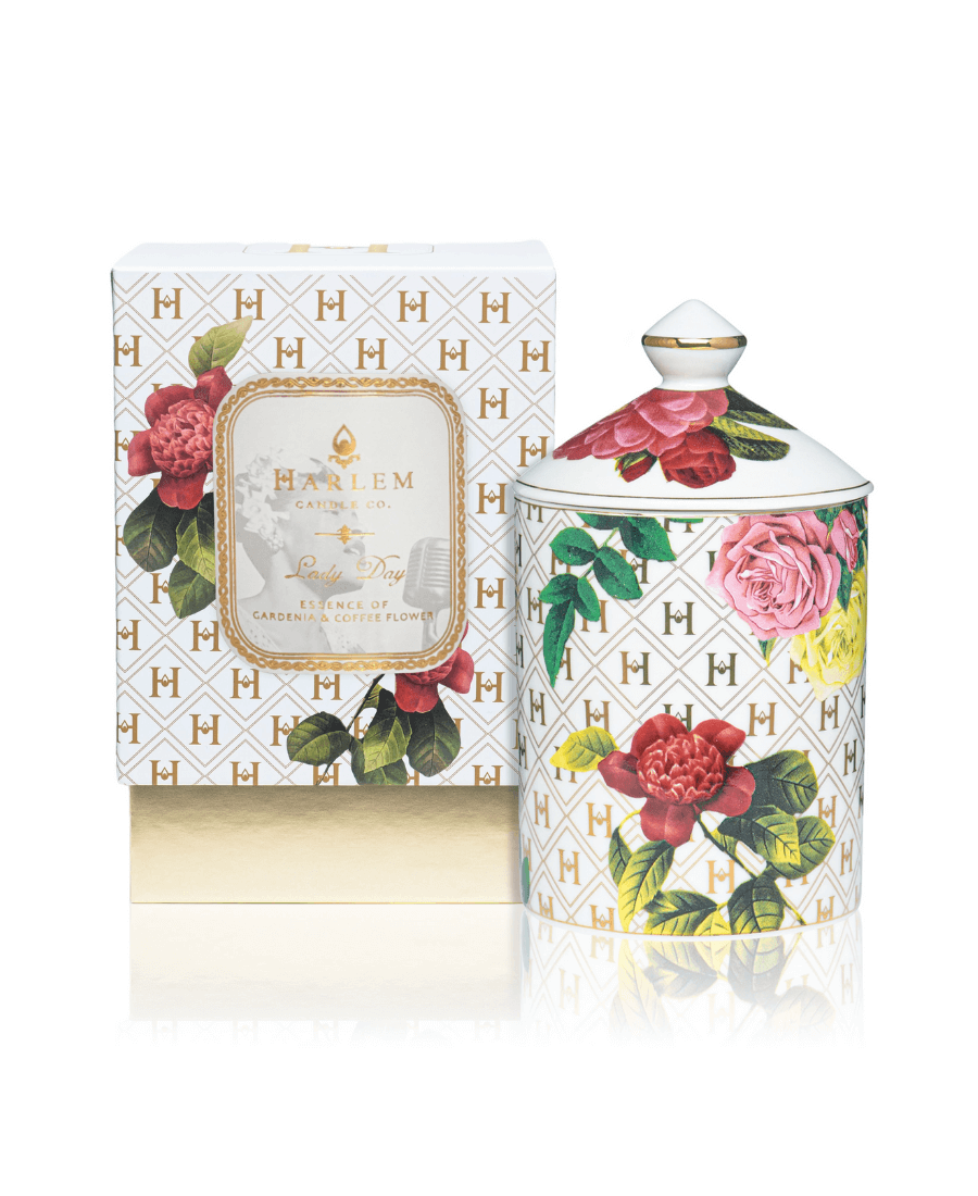 Our “Lady Day” White Floral Ceramic Luxury Candle with lid  sitting next to its gorgeous decorative box.