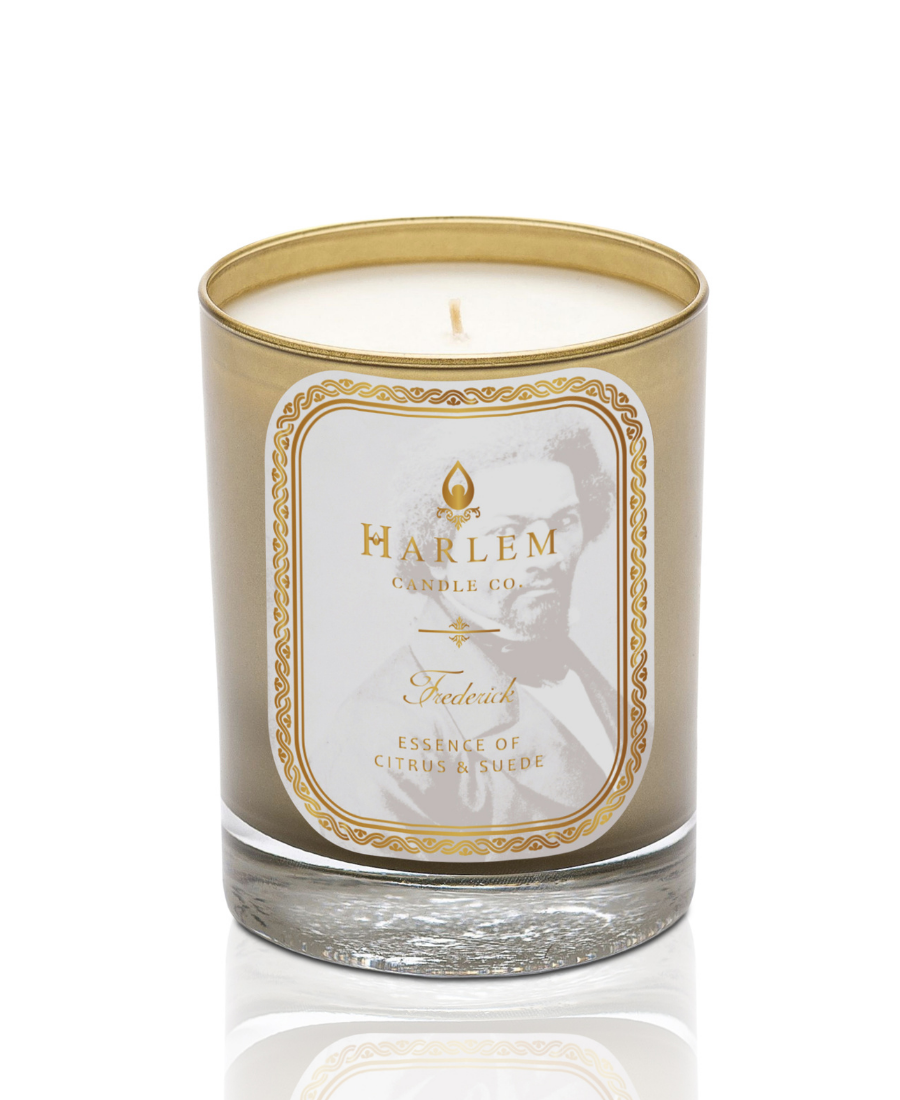 Frederick 12 oz 1 wick Luxury candle in a gold glass vessel with the essence of citrus and suede a white background.