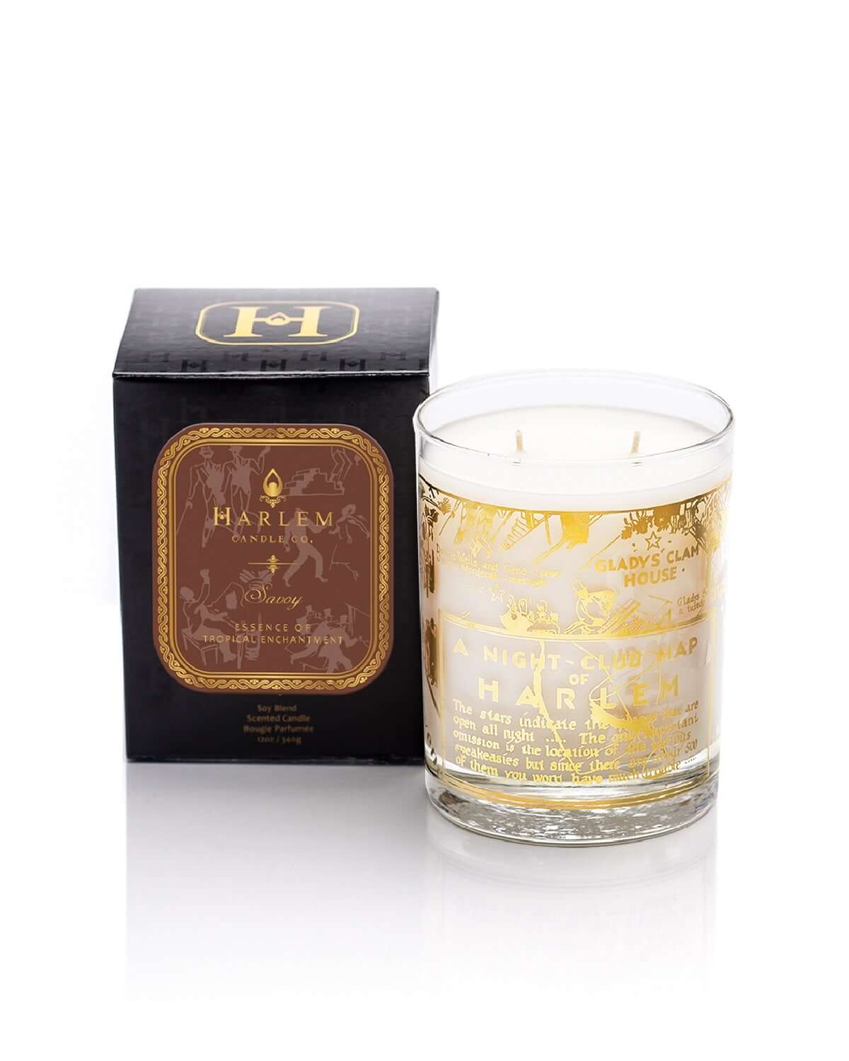 Our stunning 22K Gold Cocktail Glass Savoy 12 oz candle scents of ozone, cassis and mandarin scented candle sitting next to its decorative box on a white background. 