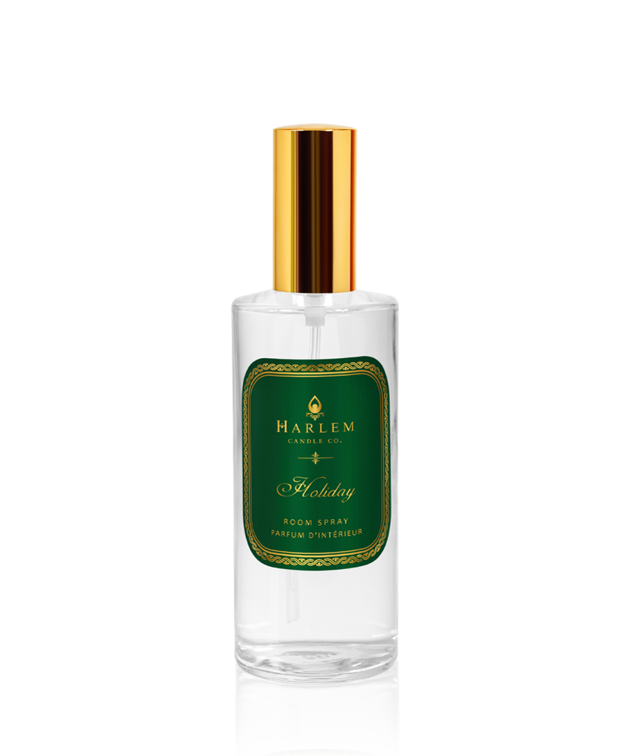 Our clear bottle of 4 oz Holiday room spray with a gold top and the essence of winter spruce on a white background.