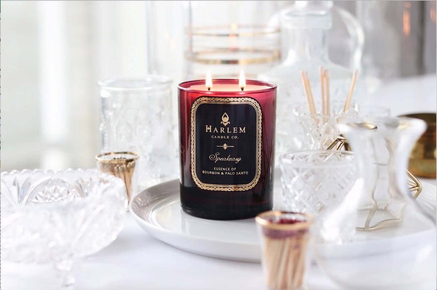 Image of the burgundy Speakeasy candle with the two flames illuminated