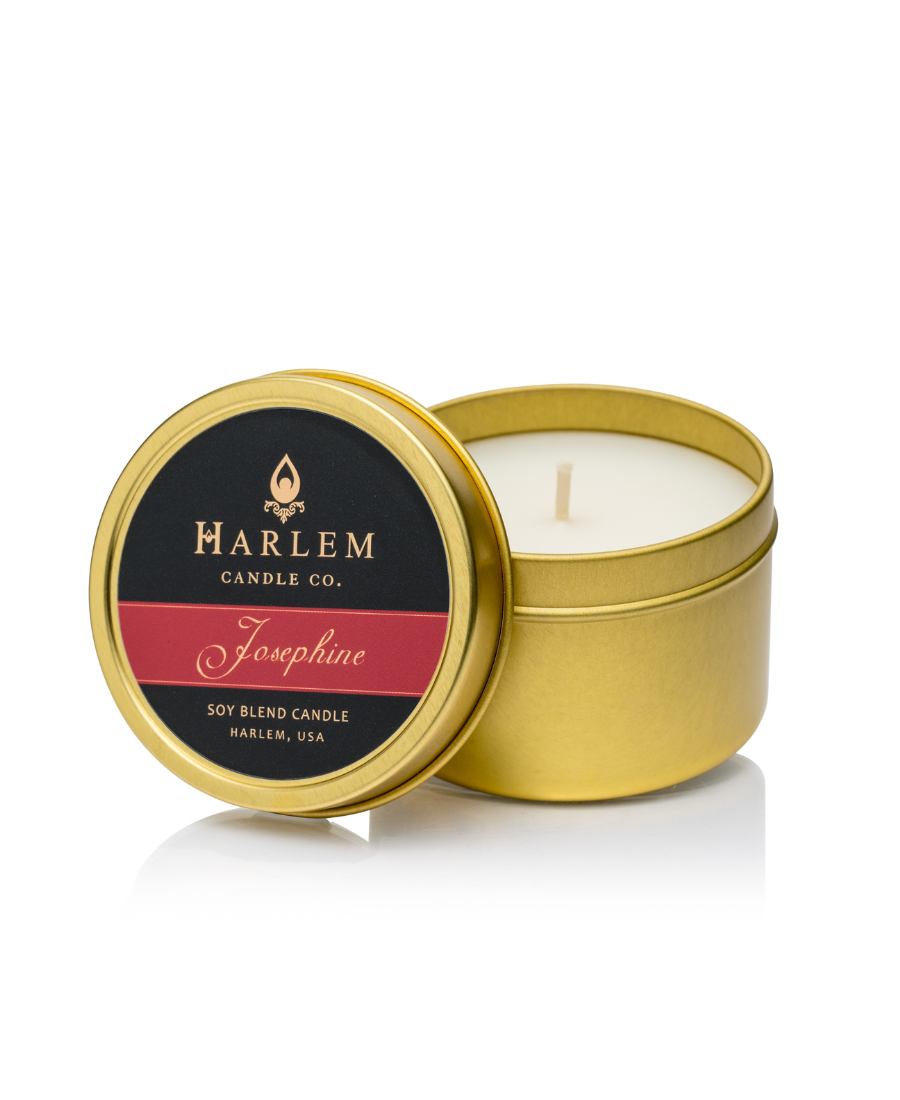 Our Josephine 4 oz Travel Candle displayed in our gold metal tin.