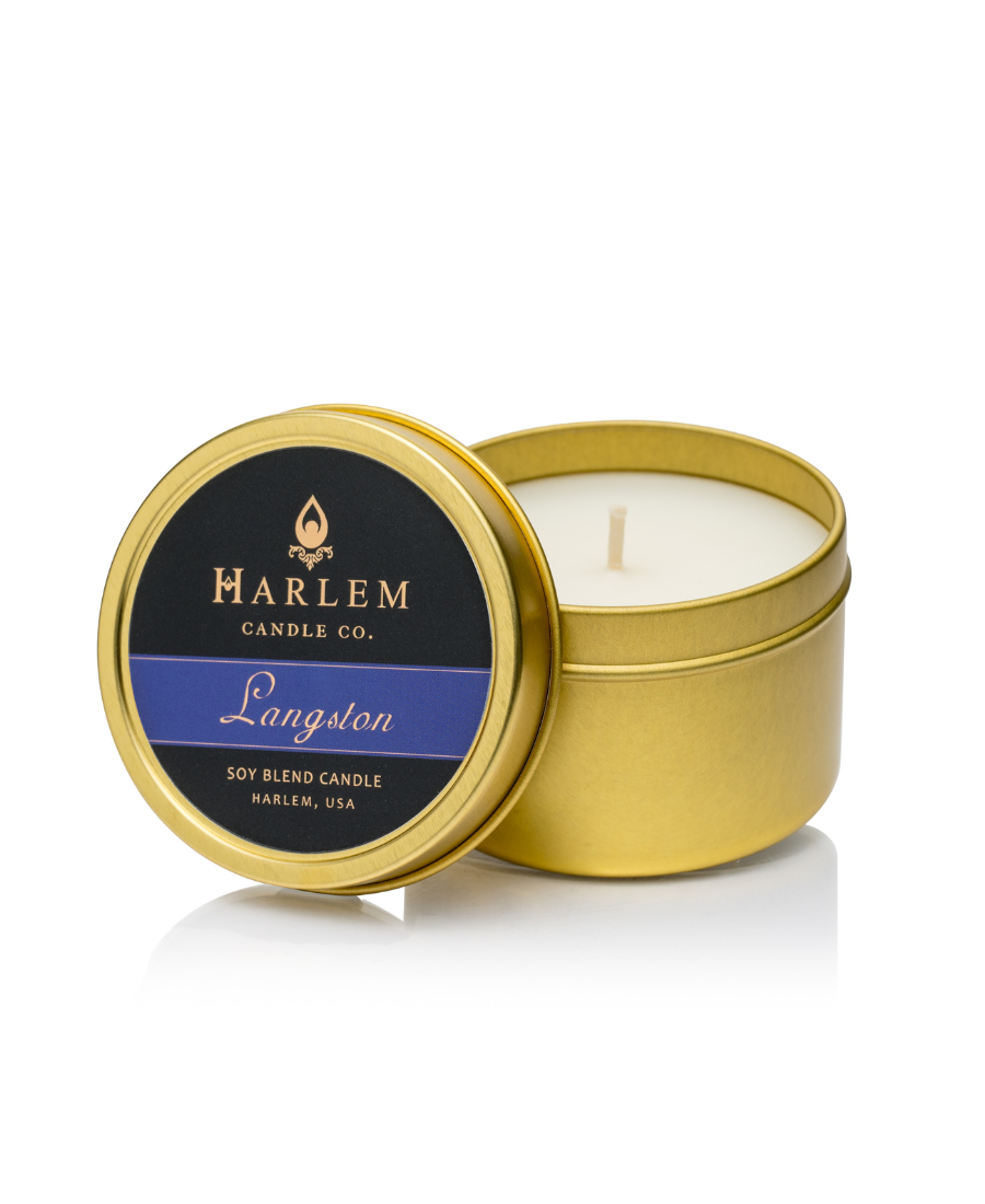 This is an image of our Langston travel candle in a bronze tin with a blue and black label on the top of the tin.