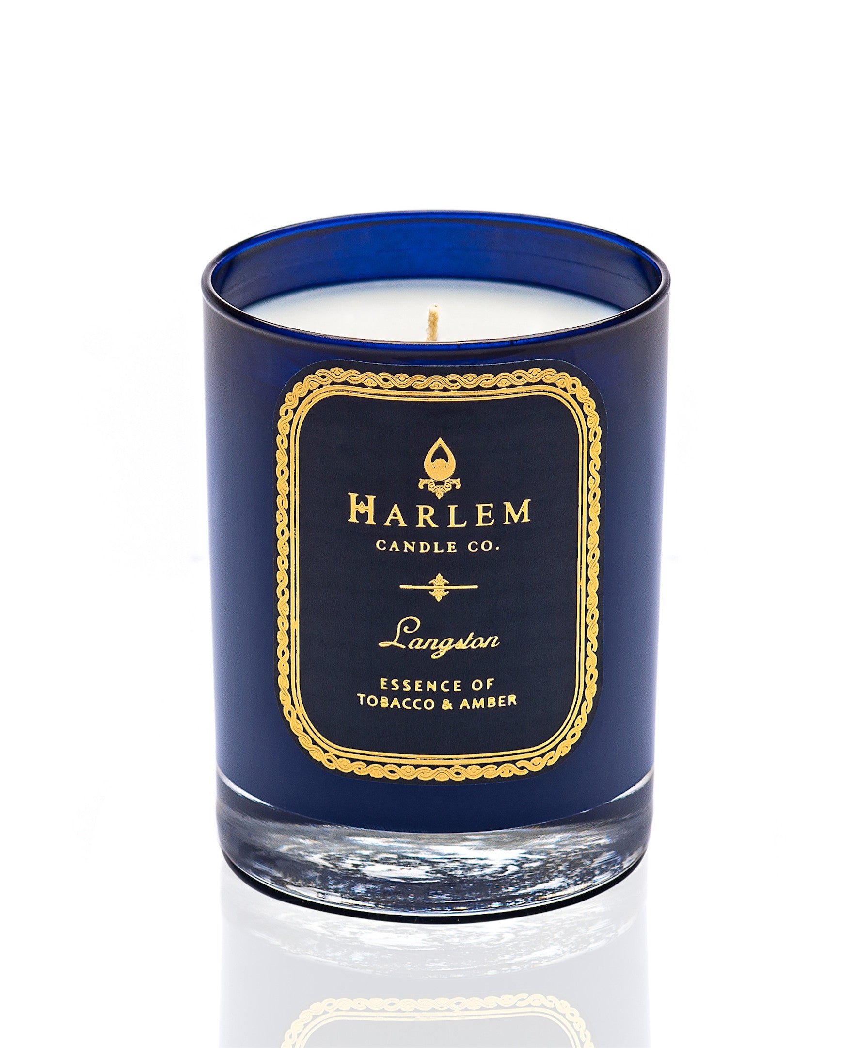 This is an image of our Langston candle in a blue glass with a single wick. It is featured on a white background.