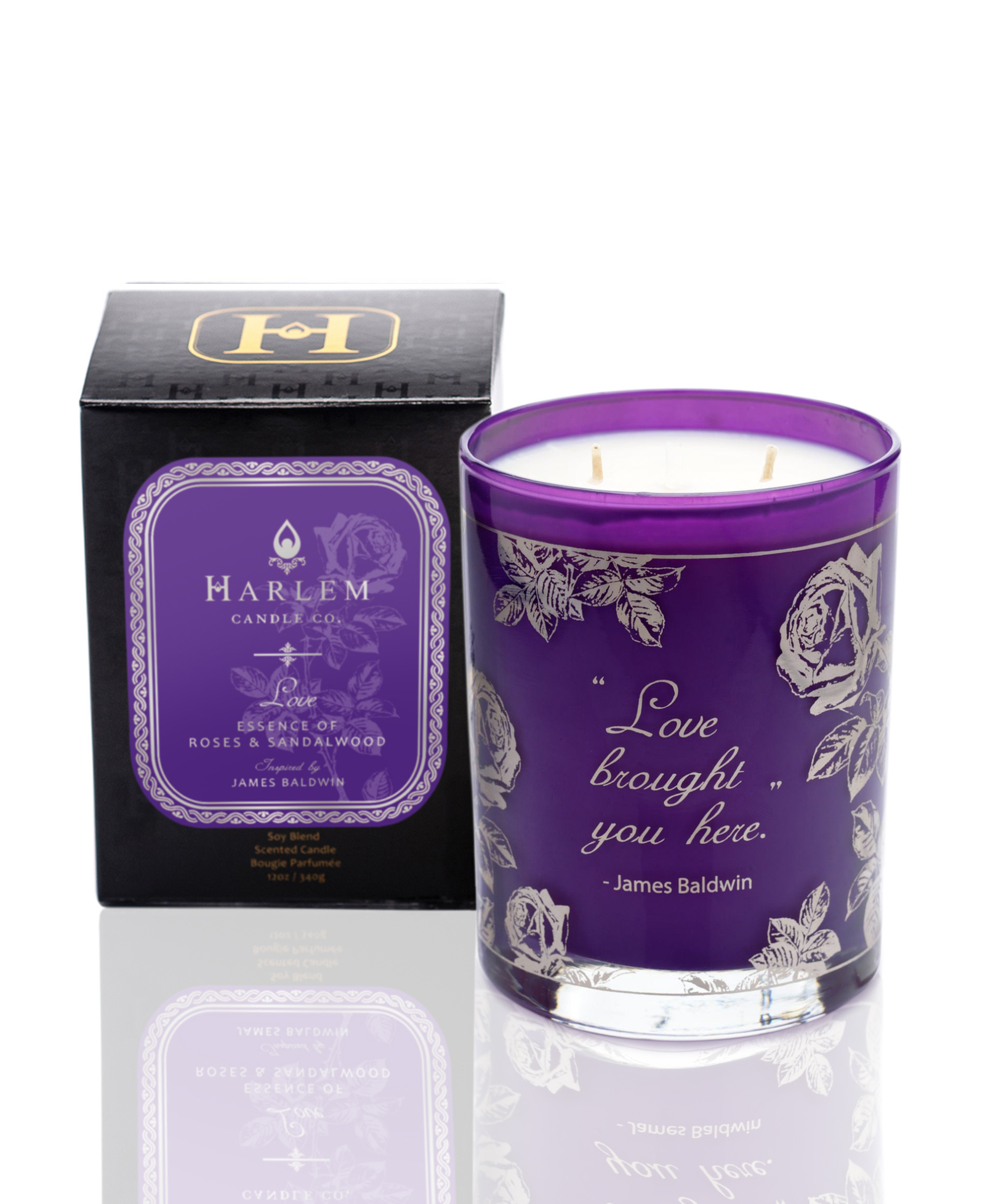 Limited edition purple and silver Love candle.  It says "Love Brought You Here" - James Baldwin. This candle is pictured next to its decorative candle box.