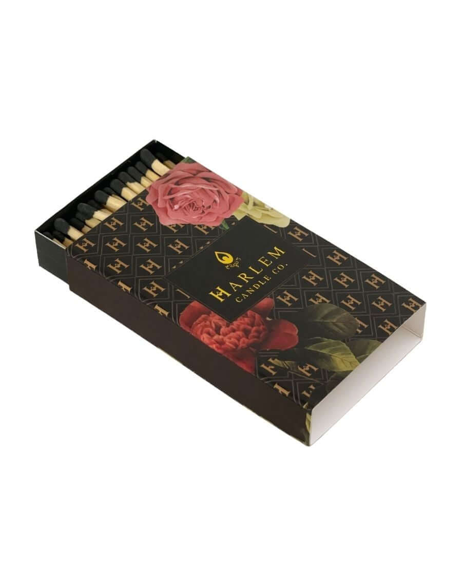 Our Black and Gold H Pattern Floral Art Deco match box with 3 inch matches with black tips set on a white background.
