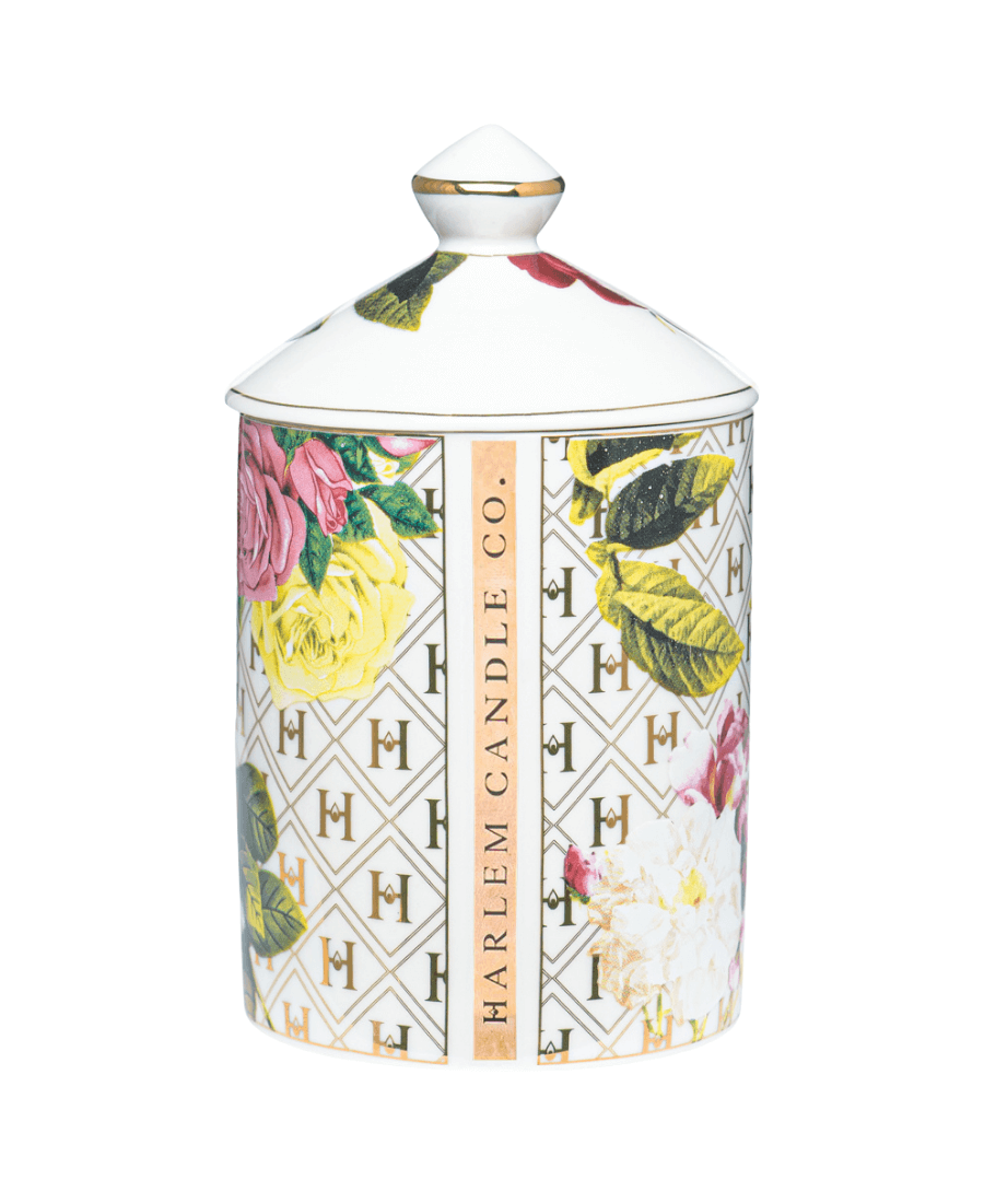 Our “Lady Day” White Floral Ceramic Luxury Candle with lid showing the back side of the vessel where Harlem Candle Co. is painted on the side.
