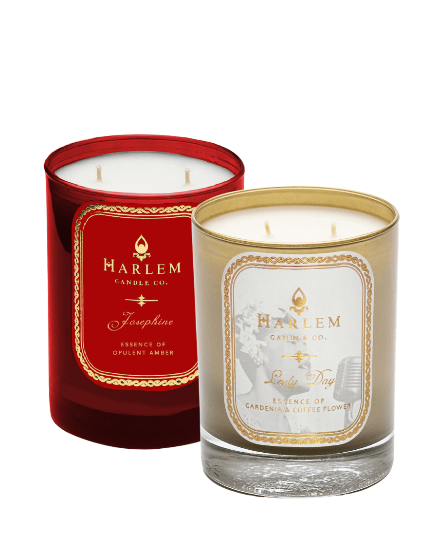 Our gold "Lady Day" 11 oz 2 wick luxury candle paired with our red 2 wick Josephine 11 oz. luxury candle placed next to each other on a white background.